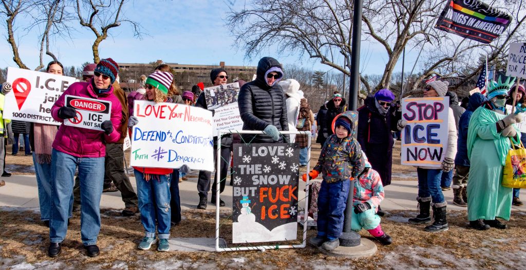 Woman with sign: I love the Snow but Fuck Ice