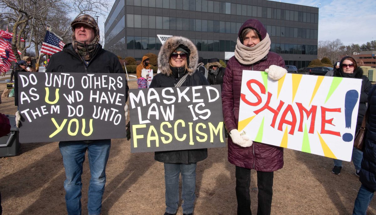 Local activists hold signs at protest