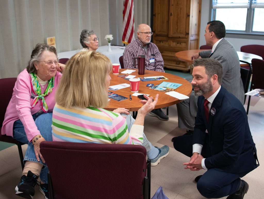 Candidates speak with voters